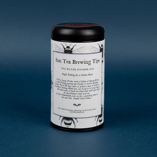 back of blueberry pomegranate sun tea tin on blue background; shows brewing instructions