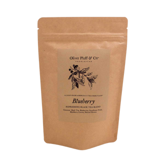 Kraft paper tea bag with 'Oliver Pluff & Co' branding and blueberry flavor text on a white background