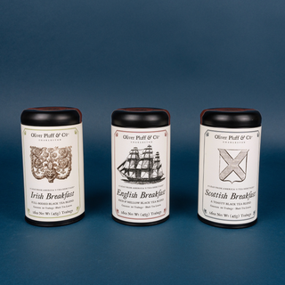 three tea tins on blue background
