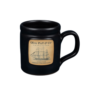 Black mug with a label featuring a ship design on a transparent background