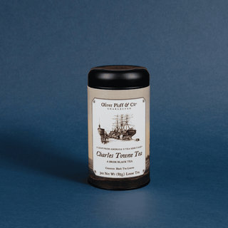 tea tin on blue background that reads 'charles towne tea' with sketch ship design
