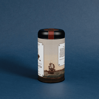 Tea canister with vintage ship design on a blue background