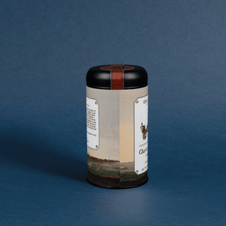 Cylindrical tea canister with a label on a blue background