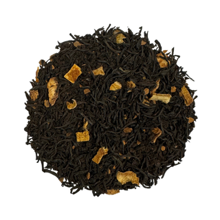 Black tea leaves with orange pieces on a white background