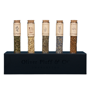 5 tubes of herbal teas with labels in black rectangular stand 