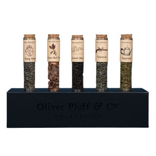 5 tubes of green, herbal or black teas with labels in black rectangular stand