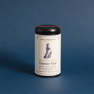 black tea tin with white label on blue background