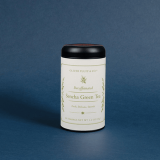 cylinder tea tin with black lid that reads decaffeinated sencha green tea on white label