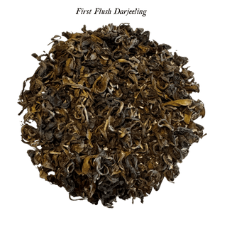 loose black tea leaves in round pile on clear background