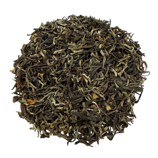 Dry black tea leaves on a white background