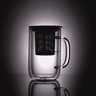 clear glass mug that reads 'oliver pluff & co' with stainless steel brewing basket resting inside and grey lid on grey background