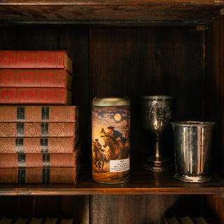 tea tin with colonial rider design on a wooden shelf with books and metal cups