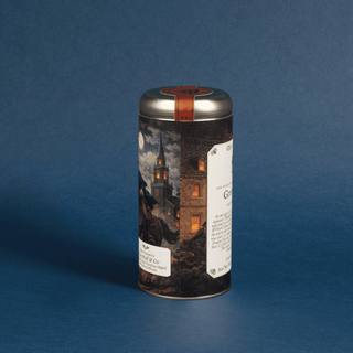 Cylindrical coffee canister with decorative label on a blue background