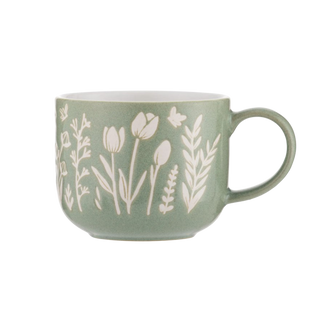 Green mug with white floral patterns on a white background