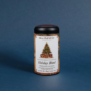 tea tin that reads holiday blend with black lid and decorative label on blue background
