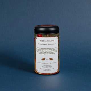 tea tin with black lid and decorative label that reads 'holiday blend' on blue background