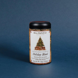 tea tin that reads holiday blend with black lid and decorative label on blue background