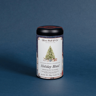 Tea canister labeled 'Holiday Blend' with a Christmas tree and presents design on a blue background