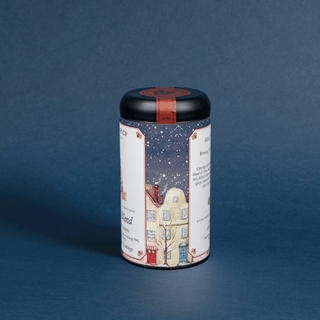 Cylindrical tea canister with decorative label on a blue background