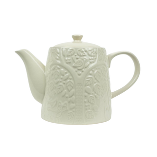 textured white teapot on white background