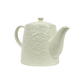 textured white teapot on white background