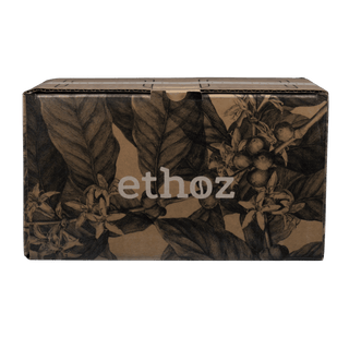 Cardboard box with coffee plant design and 'ethoz' branding on a transparent background