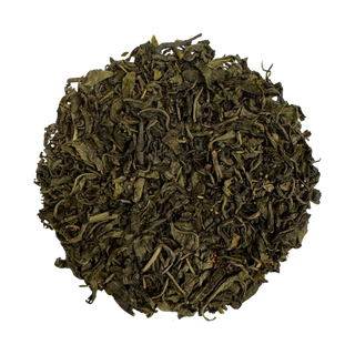 Dry green tea leaves on a white background