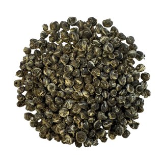 Pile of small, rolled green tea leaves on a white background