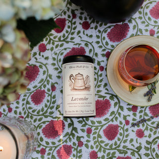 Lavender tea packaging with a cup of tea on a floral tablecloth