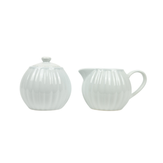 White ceramic teapot and creamer set on a white background