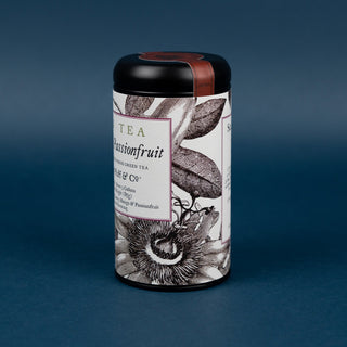 Tea canister with passionfruit design on a dark blue background