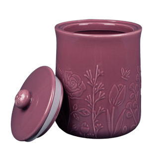 Purple ceramic jar with floral embossing and matching lid on a white background