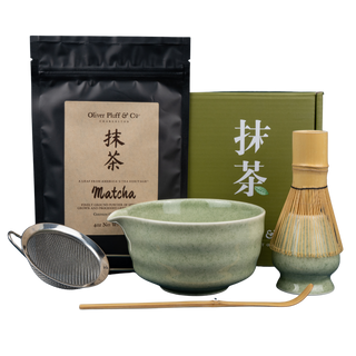 Oliver Pluff & Co. Matcha Gift Set with 4 oz organic matcha, ceramic bowl, bamboo whisk, scoop, holder, and sifter on clear background