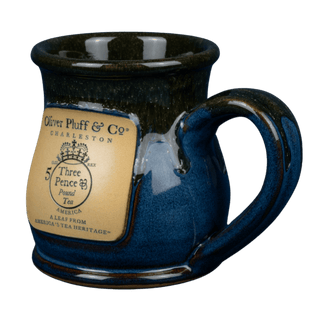 blue and brown mug on clear background with front emblem that says 'oliver pluff & co' and has the east india company tea tax logo
