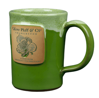 Green mug with a label featuring 'Oliver Pluff & Co' on a transparent background