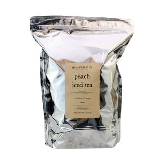 Silver packaging of peach iced tea with a label on a white background