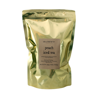 Gold packaging of peach iced tea with text on a white background