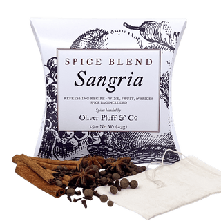 black and white tea pouch with cinnamon sticks, cloves, allspice, star anise and a tea bag scattered in front 