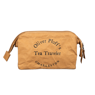 Brown pouch with 'Oliver Pluff's Tea Traveler Charleston' text on a transparent background
