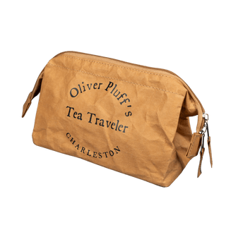 Brown bag with 'Oliver Pluff's Tea Traveler Charleston' text on a transparent background