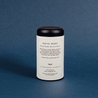Tea canister labeled 'White Peony' on a blue background