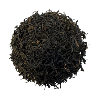 Pile of black tea leaves on a white background