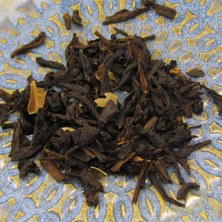 loose leaf tea sprinkled on blue and yellow plate