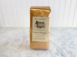 shiny gold coffee bag with old timey house graphic on label