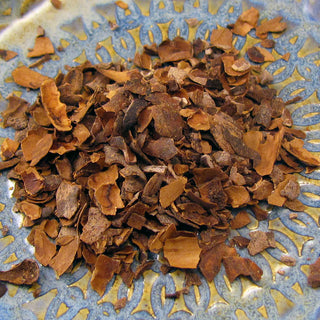 goldish loose leaf flakes on a pile on top of blue and yellow plate