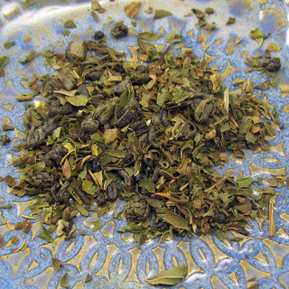 pile of loose leaf tea on blue and yellow plate