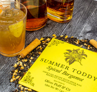  Cinnamon Sticks, Black Tea, Ginger, Lemon Peel, Cloves, Bergamot on table with clear glasses of tea and the OP logo