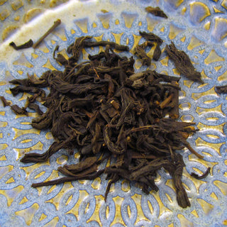 pile of loose leaf tea sitting on blue and yellow plate