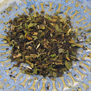 pile of loose leaf tea on blue and yellow plate