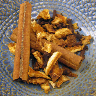 cinnamon sticks and loose leaf tea in blue bowl